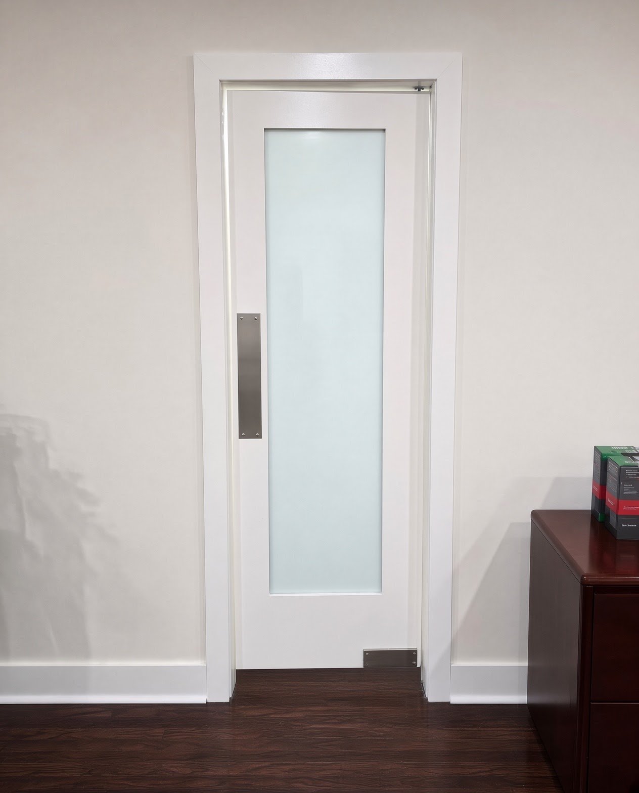 White interior door with a frosted glass panel
